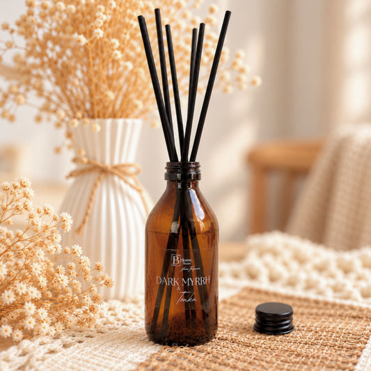 Dark Myrrh and tonka reed diffuser, amber bottle diffuser, placed on  the table and dried pampas
