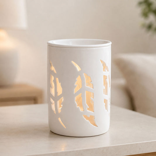 white Feather wax melt burner on the table in a light home background