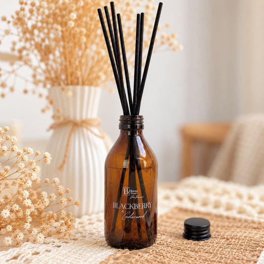 blackberry and cedarwood reed diffuser places on the table with dried papas around 