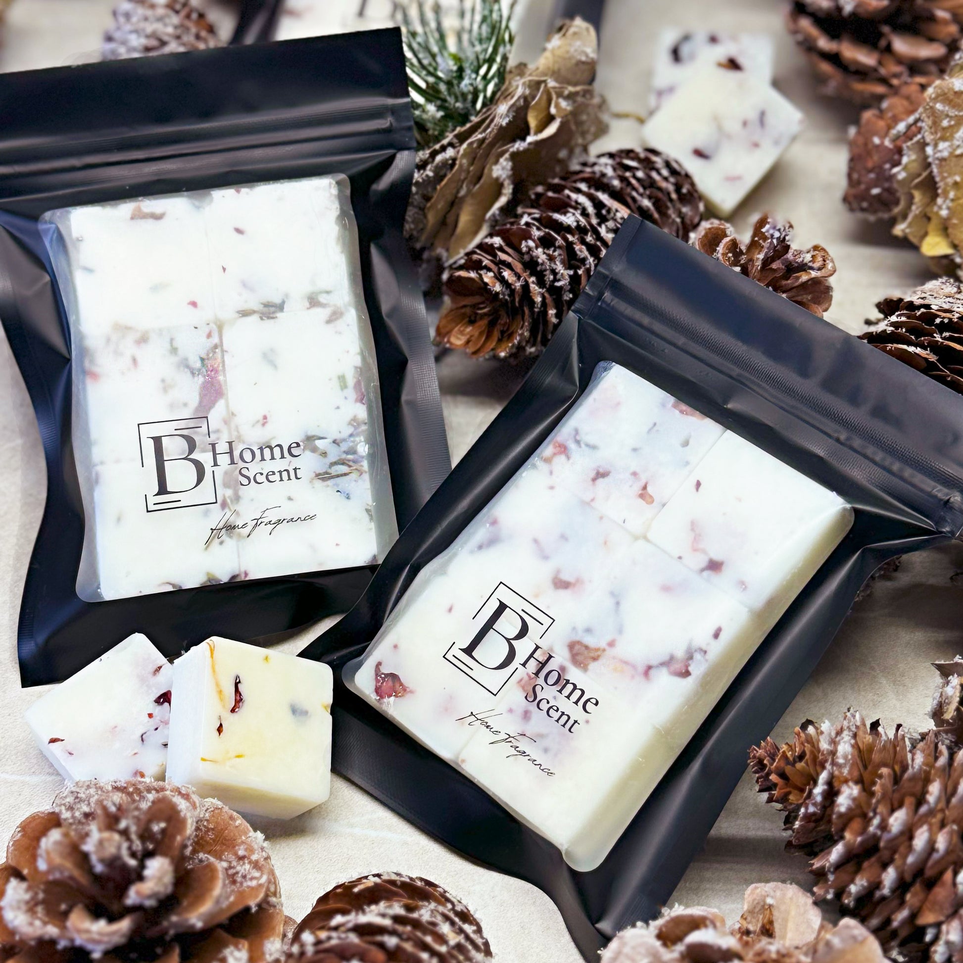 Nutcracker wax melt snap bars in black packaging surrounded by pinecones and winter decorations.