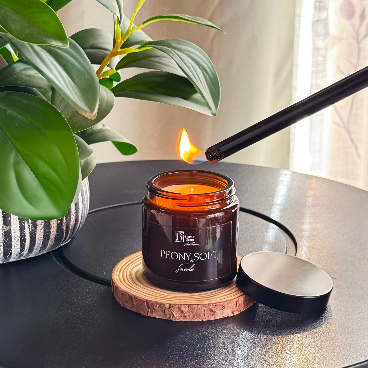 lighting amber candle UK peony suede scent with floral fragrance and cosy setup