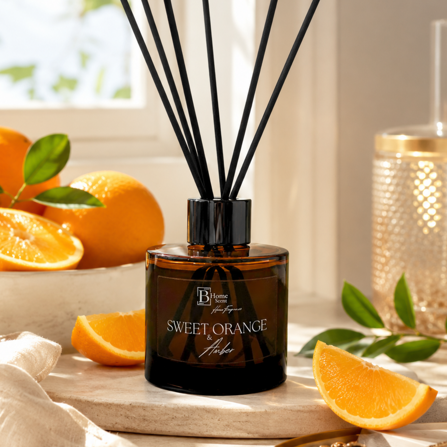 Sweet Orange and amber reed diffuser with oranges and leaves on a wooden surface